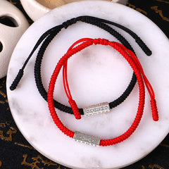 Red String Om Mani Padme Hum Bracelet - Pair on marble with tea ceremony props, lucky bracelet