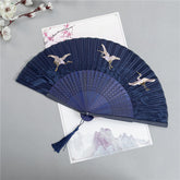 Crane Silk Folding Fan – Navy fan with white cranes in flight over waves, silk folding fan