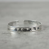 Tibetan Mantra Copper Bracelet - Side view of polished open cuff with engraved mantra, Tibetan bracelet