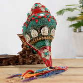 Turquoise Shankha Conch – front view with Avalokitesvara carving and turquoise inlay on shell, Tibetan art