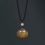 Om Mani Padme Hum Necklace – Carved lotus dome pendant with gold metal rim and perforated lid, jade bead, diffuser