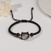 Silver sheen obsidian cat head bracelet with black beads on adjustable black cord, minimalist gold-accented kitty protection jewelry