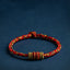 Handmade red braided cord bracelet with gold accent beads, adjustable Chinese knot lucky string bracelet on navy background