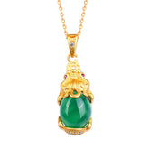 Natural Jade Pixiu Necklace – green jade Pixiu pendant on gold chain white background, prosperity