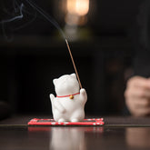 Mini Cute Cat Ceramic Incense Burner – White cat with red collar and gold bell holding burning incense, Japanese zen decor