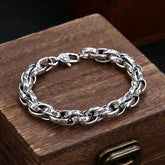 Tibetan Om Mani Padme Hum Copper Bracelet – carved silver links on antique wooden chest, vintage jewelry