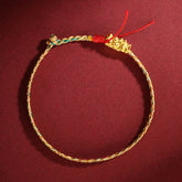 Colorful Dragon Carved Braided Bracelet – Gold dragon head on multicolor braided cord circle, flat lay view, Handcrafted