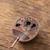 Copper Incense Burner Set – fan-shaped copper burner with lotus relief and cloud vents on wood