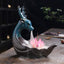 Little Deer Ceramic Lotus Incense Burner – Iridescent teal deer with pink lotus, cascading smoke on wood, backflow incense