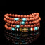 Goldstone Mala Bracelet – coiled multi-strand goldstone beads with turquoise on black, prayer jewelry
