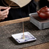 Mountain Lake Incense Burner – Purple mountain landscape ceramic plate with brass holder in tea ceremony setting