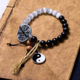 Cat's Eye Ebony Wood Yin Yang Bagua Coin Bracelet – Black and white beads with Bagua coin, yin-yang charm and tassel