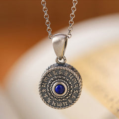 Om Mani Padme Hum Pendant – Frontal close-up with blue stone center and silver chain, meditation necklace