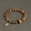 Brown beaded bracelet with focal bead and metal-colored spacers