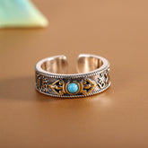 Turquoise Vajra Ring – front view silver open band with turquoise and gold vajra on brown surface, mantra ring