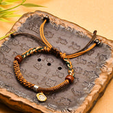 Tibetan Cord Bracelet – brown woven cord with wood beads and gold charm on carved stone, protection jewelry