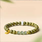 Green Sandalwood Bracelet – Single wrap with green Hetian jade and gold lock charm on beige, natural wood