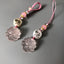 Quartz Fox Keychain – pair of pink crystal nine-tailed fox pendants with lotus beads on grey background, love crystal jewelry