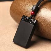Black Obsidian Pendant – Black obsidian guard plaque with cloud carving and red bead by brown pottery, protection amulet