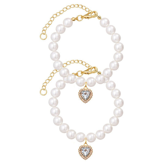 Princess Pearl Pet Collar – two pearl collars with clear heart crystal pendants, gold chain extender, flat lay