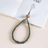 Zodiac Wood Bead Lanyard – Green sandalwood beaded phone strap with carved lotus top on white book, Zen fortune accessory