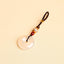 Jade Keychain Pendant – White jade donut pendant with braided rope and bodhi beads on beige background, feng shui