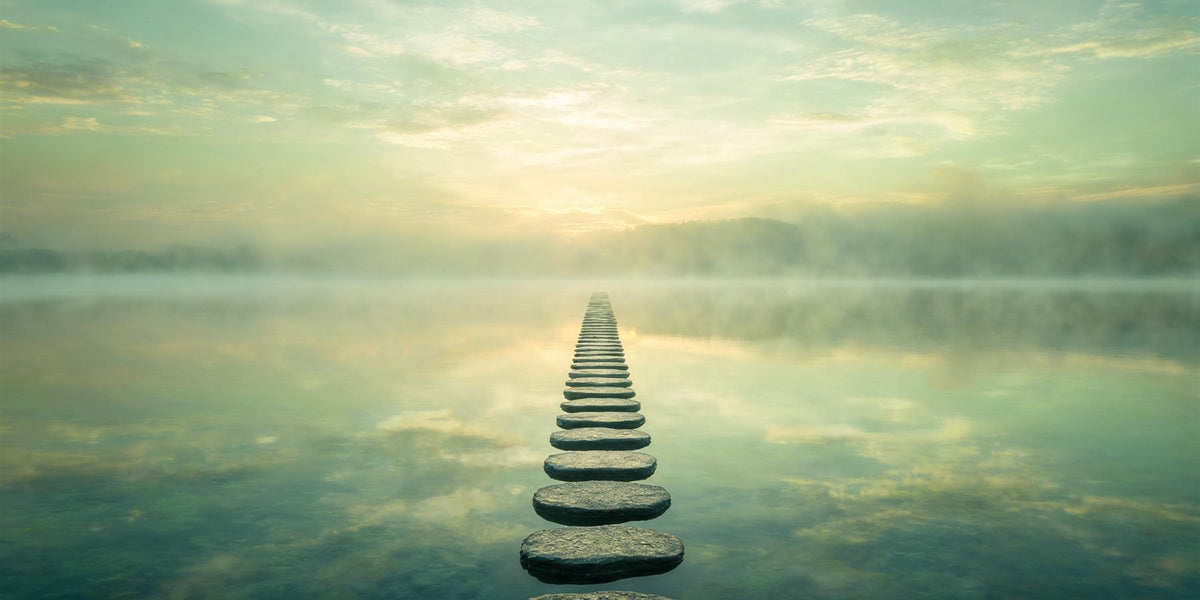 1234 angel number meaning - a series of stepping stones across calm water in a green and gold landscape, step-by-step progress