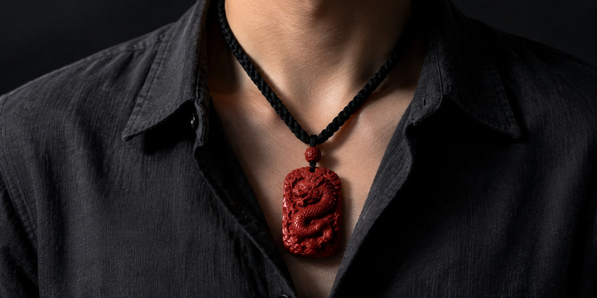 Man wearing a carved cinnabar dragon pendant on a black cord
