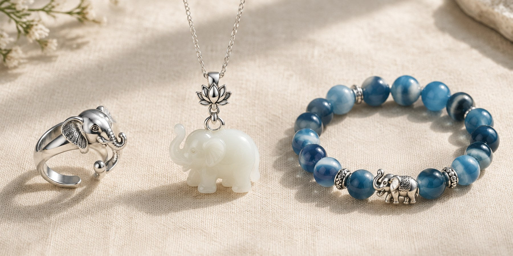 Silver elephant ring, white jade elephant pendant and blue agate elephant bracelet on linen