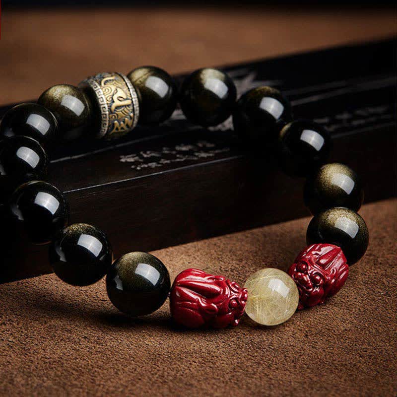 Gold Sheen Obsidian Pixiu Bracelet – lying on bamboo scroll, strong golden sheen on obsidian beads with mantra spacer