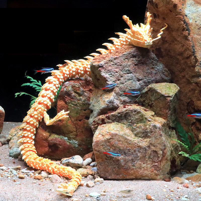 Feng Shui 3D Dragon - Warm golden dragon resting on rock formation in planted aquarium, fortune charm