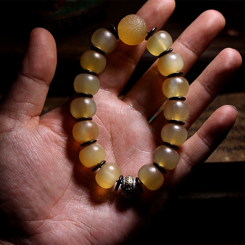 Tibetan Sheep Horn Skull Bracelet – On open palm, carved accent bead and dark metal focal charm visible