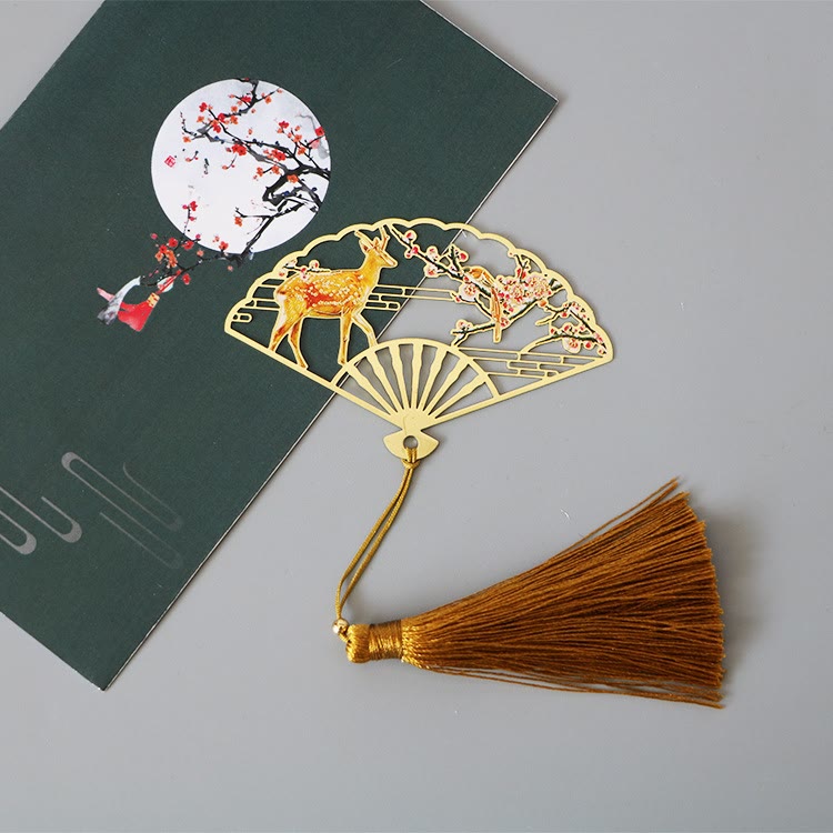 Brass Hollow Fan Bookmark - Deer and blossom cutout with amber tassel on book, nostalgic