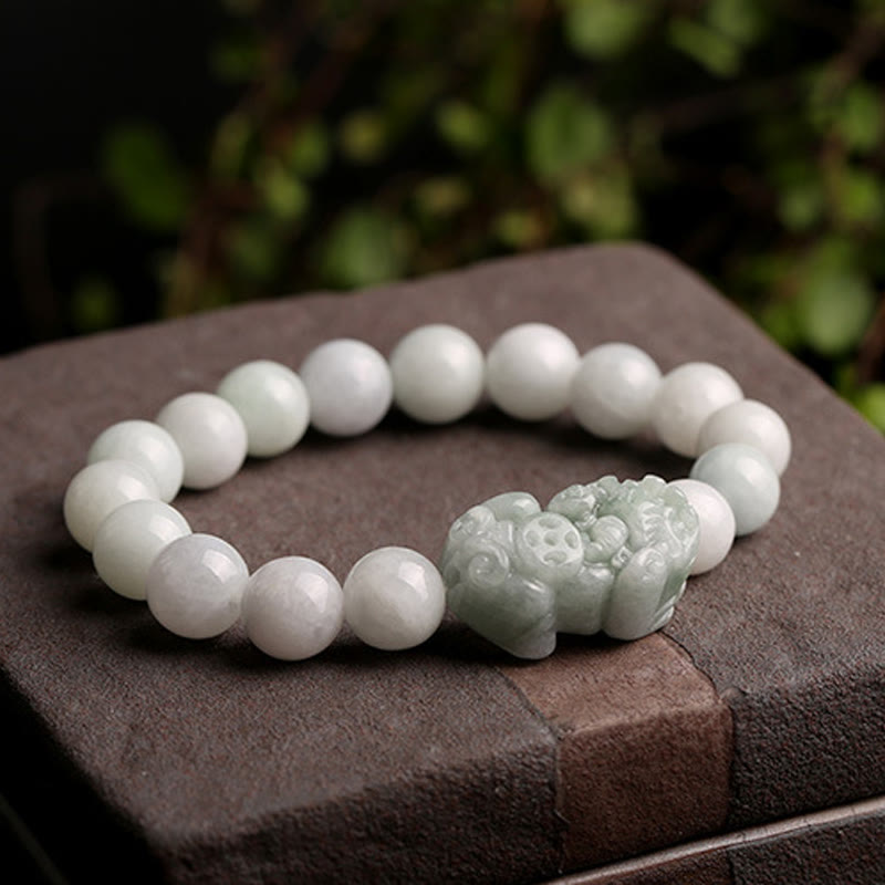 Jade PiXiu Bracelet – Resting on brown stone with green leaves, outdoor style, jade protection charm