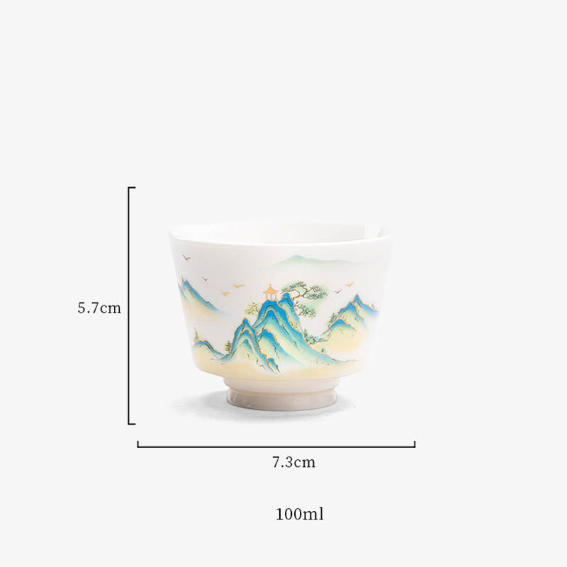 Ceramic Kung Fu Tea Cup – deer on blue-gradient mountain ridge with pine trees, dark wood table, low angle, tranquil
