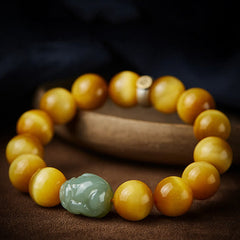 Zodiac Tiger Eye Jade Bracelet – Golden beads jade PiXiu on wooden pedestal dark background