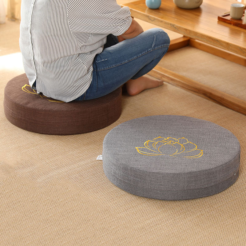 Lotus Meditation Cushion - Person seated on brown zafu with gray cushion nearby, lifestyle