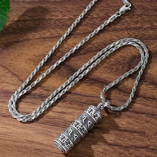 Copper Om Mani Padme Hum Necklace – Top-down view of cylindrical prayer wheel pendant with Tibetan mantra engravings on silver rope chain, spiritual pendant