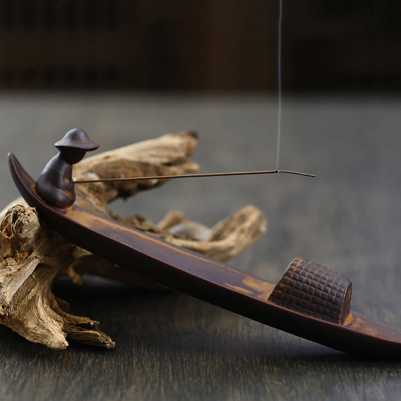 Lonely Fisherman Incense Holder – Clay boat with seated figure and smoke on aged wood, zen decor