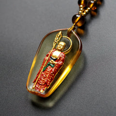 Ksitigarbha Buddha Liuli Crystal Necklace – Glowing amber deity pendant on beaded chain, Buddhist spiritual jewelry