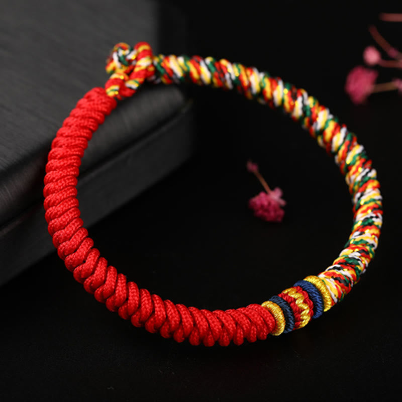 Handwoven red Tibetan king kong knot bracelet with five-color multicolor braid section gold navy blue transition bands and adjustable sliding knot closure