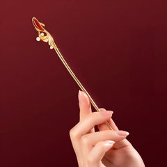 Koi Hairpin – hand holding the gold pin against deep red background, koi head detail, gift idea