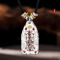 Golden Light Pendant – textured silver talisman with red charms and gold emblem on black cord, protection wealth luck amulet