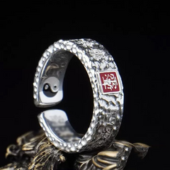 Tian Guan Ci Fu Ring – silver hammered ring with red square stamp on ornate base, blessing protection amulet ring