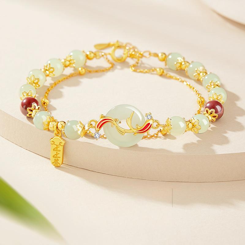 Hetian Jade Bracelet – Pale green jade beads gold chain with koi peace button and red accent beads on beige, luxury luck