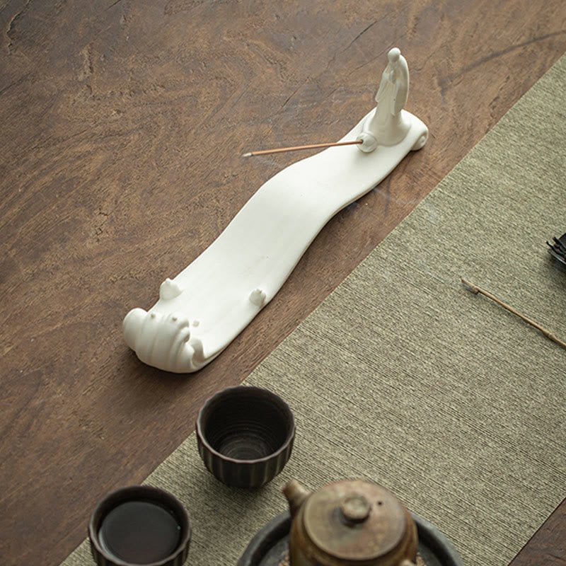 Buddha Monk Sea Wave Mountain Ceramic Incense Burner – Overhead view of white monk wave holder with tea set and loose incense, zen lifestyle