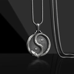 Yin Yang Dragon Pendant – Antiqued silver medallion with sculpted dragon S-curve on black, Spiritual