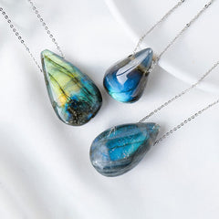 Labradorite water drop pendant necklace trio showing three natural teardrop labradorite cabochons with varying blue teal and golden iridescence on fine silver cable chains