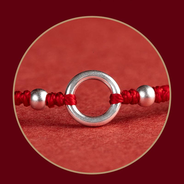 Sterling Silver Lotus Peace Buckle Red String Bracelet – Macro detail of the sterling silver peace buckle ring flanked by two silver beads on red cord with traditional Chinese knotting