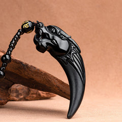 Black Jade Dragon Tooth Pendant – wolf head carved obsidian fang, diagonal arc on bark, guardian energy